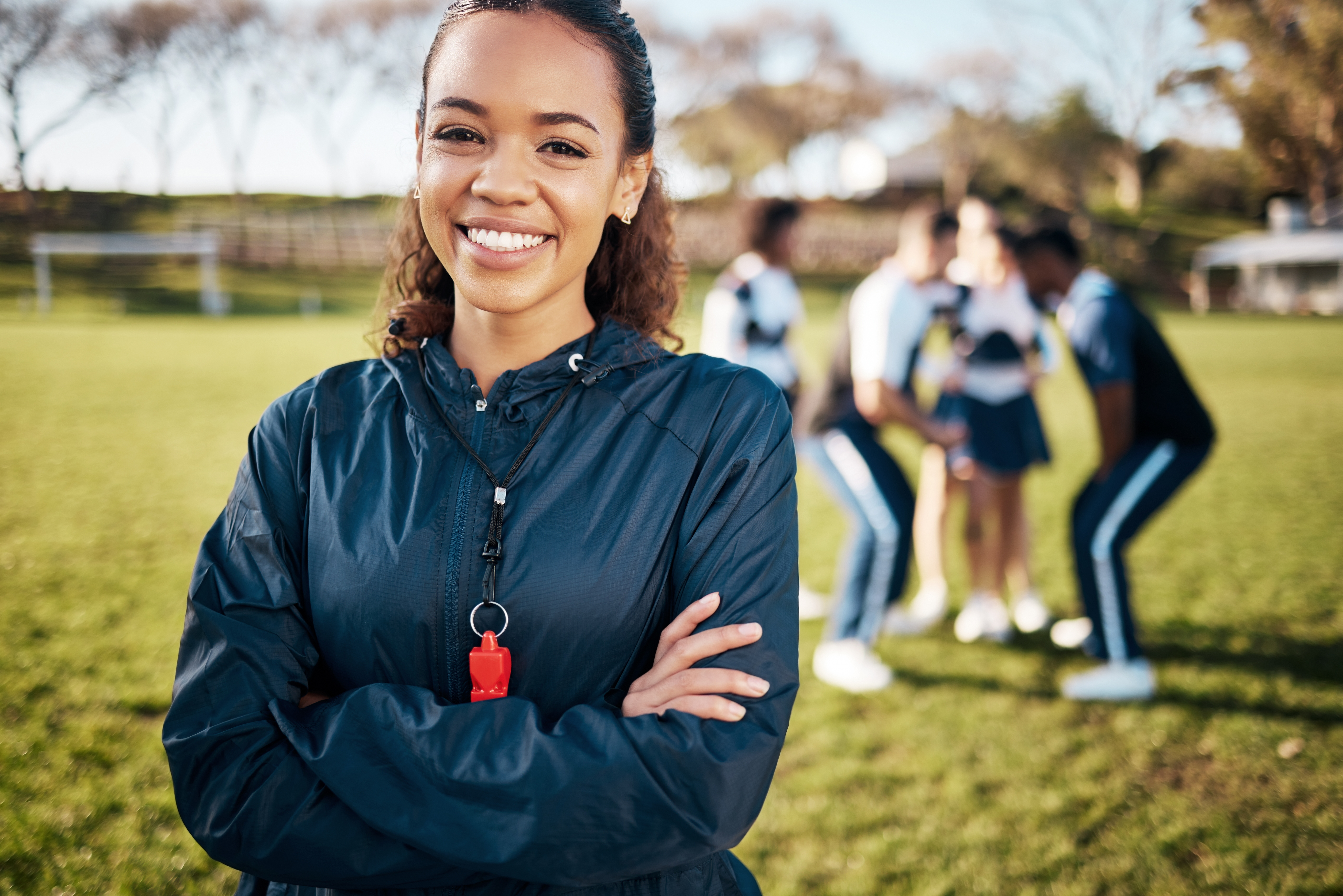 sports coach with her team; why is a sports payments system important? | Biz Core
