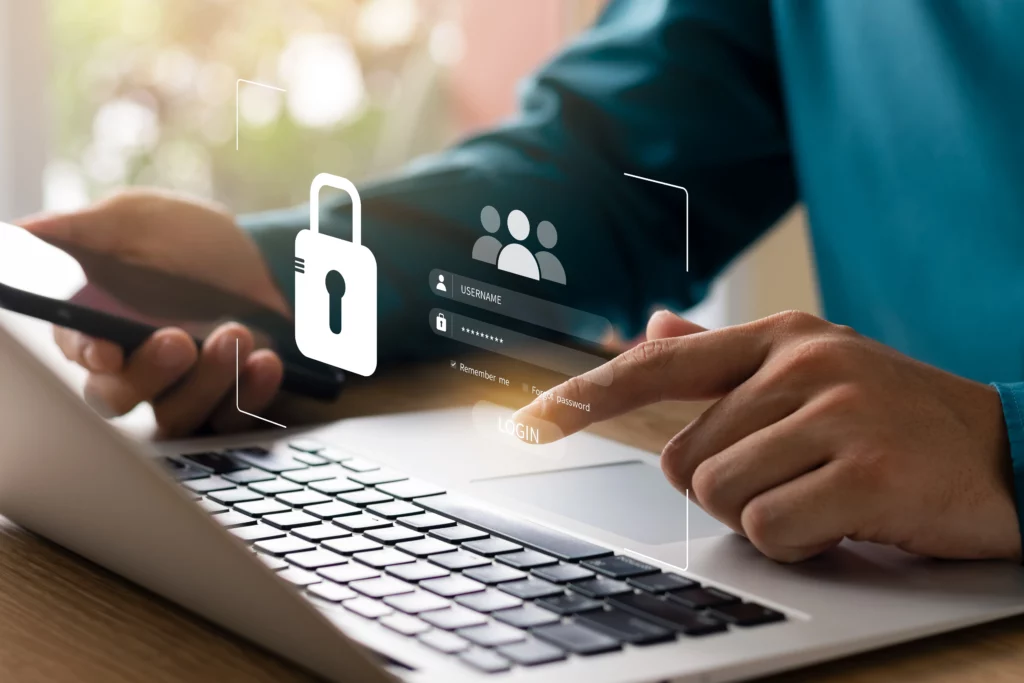 Close up of a person's hands using a laptop with a password and lock graphic floating in the air in front of the screen